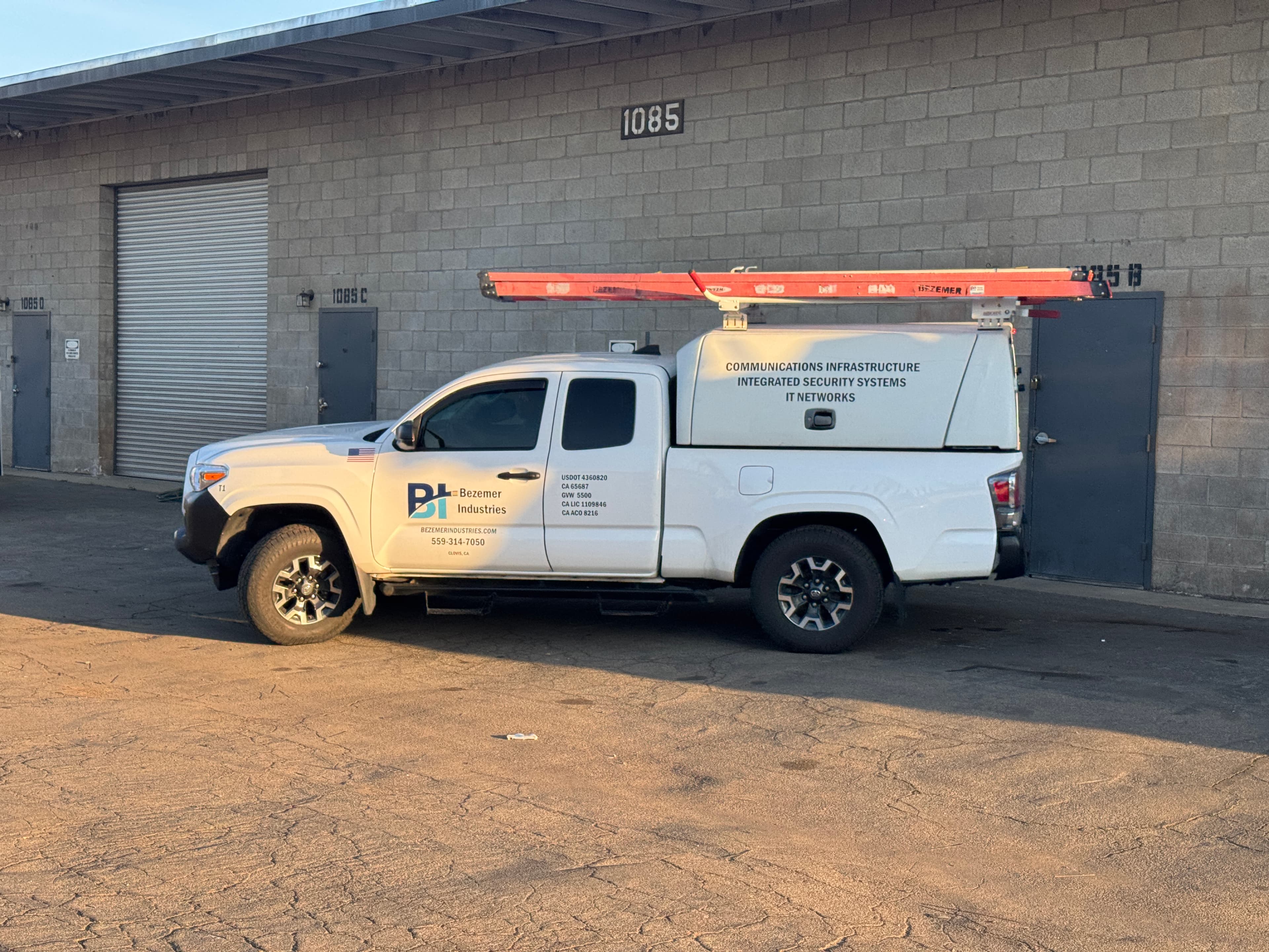 Bezemer Industries branded work truck outside a commercial facility